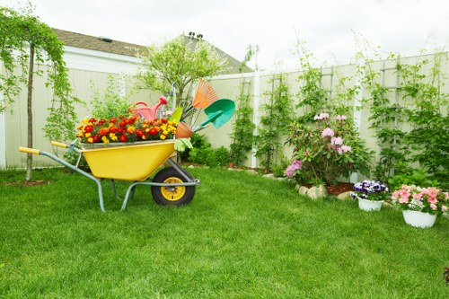 Garden maintenance team pruning and tidying a suburban garden